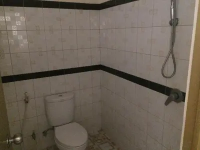 a bathroom with a toilet and a shower at Simple apartment 3 in Seminyak