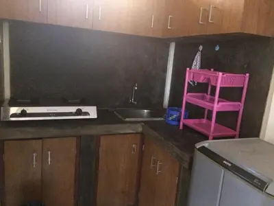 a kitchen with a pink stool and a sink at Simple apartment 3 in Seminyak