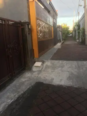 an empty alley with a door and a building at Simple apartment 3 in Seminyak