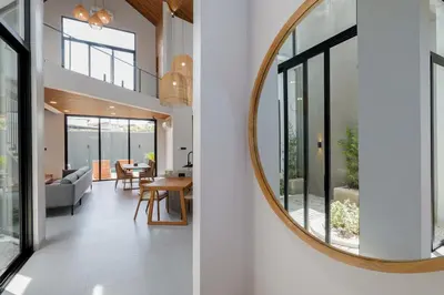 a large round mirror on the wall of a house at Rumah Christa in Seminyak