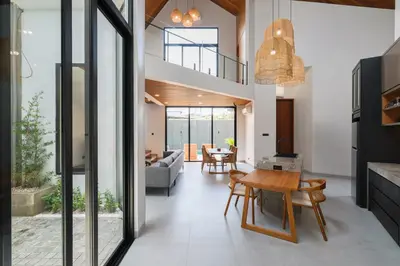 a living room with a table and a dining room at Rumah Christa in Seminyak