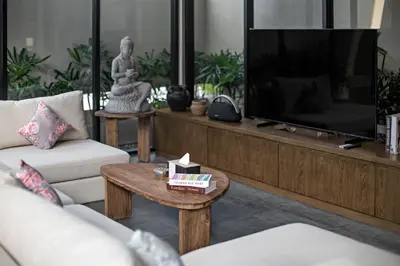 a living room with a television and a coffee table at D'Padi Villa Canggu in Canggu