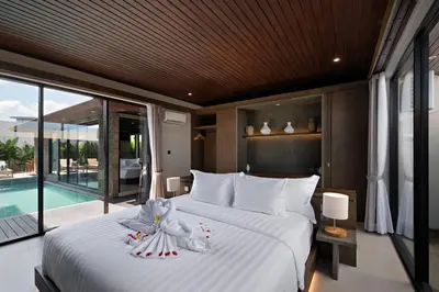 a bedroom with a bed and a swimming pool at D'Padi Villa Canggu in Canggu