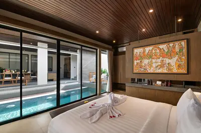a bedroom with a bed and a swimming pool at D'Padi Villa Canggu in Canggu