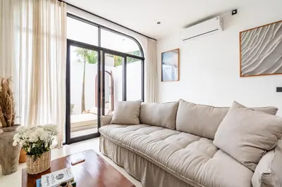 a living room with a couch and a table at Casa Nalani in Kerobokan
