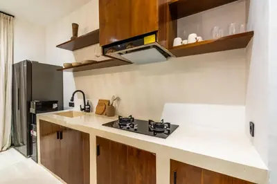a kitchen with a sink and a stove at Casa Nalani in Kerobokan
