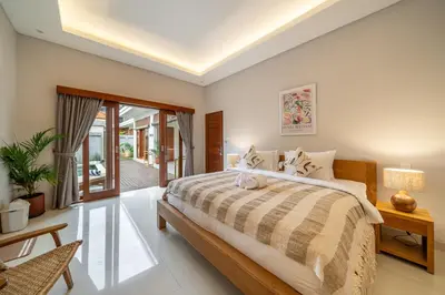 a bedroom with a large bed in a room at Sunterra 3- Luxurious 3BR Villa in Canggu with Pool in Kerobokan