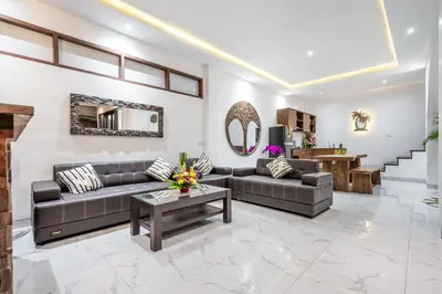 a living room with couches and a table at Villa Bima by JB Villas in Seminyak