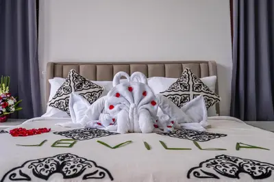 a towel animal is sitting on top of a bed at Villa Bima by JB Villas in Seminyak