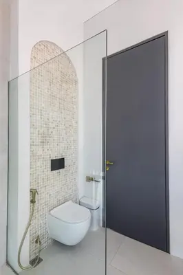 a bathroom with a toilet and a glass shower stall at Brand New Luxury 5 Stars Designer Villa by Amare Villas in Kerobokan