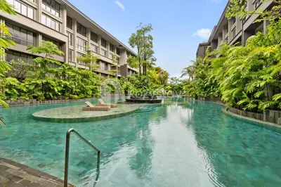 a swimming pool in the middle of a building at Calira by Kozystay - Nusa Dua in Nusa Dua
