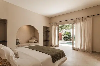 a bedroom with a large bed and a large window at 3 Bathroom Bali villa in Kerobokan