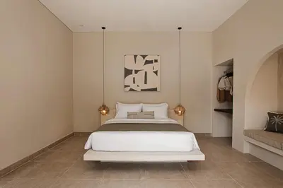 a bedroom with a large white bed and a couch at 3 Bathroom Bali villa in Kerobokan
