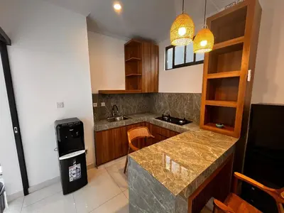a kitchen with a counter and a trash can at Ben & B villa in Kerobokan