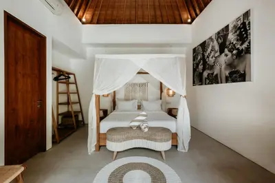 a bedroom with a bed with a canopy at Villa Pacha Seminyak in Seminyak