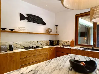 a kitchen with a fish sculpture on the wall at Villa Pacha Seminyak in Seminyak