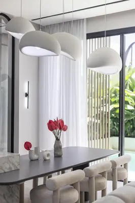 a dining room with a table and chairs and pendant lights at Brand New Luxury5 Stars Designer By Villa Amare Villa 3 in Kerobokan