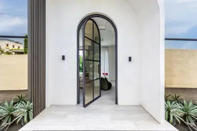 an entrance to a house with a glass door at Brand New Luxury5 Stars Designer By Villa Amare Villa 3 in Kerobokan