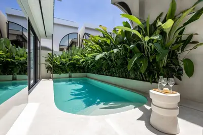 a swimming pool in a building with plants at Brand New Luxury5 Stars Designer By Villa Amare Villa 3 in Kerobokan