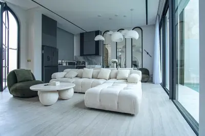 a living room with a white couch and a table at Brand New Luxury5 Stars Designer By Villa-Amare Villa 1 in Kerobokan