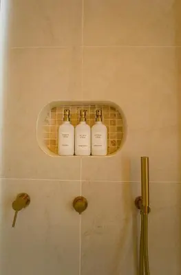 a group of four bottles on a shelf in a bathroom at Brand New Luxury5 Stars Designer By Villa-Amare Villa 1 in Kerobokan