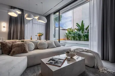 a living room with a couch and a large window at Brand New Luxury5 Stars Designer By Villa-Amare Villa 5 in Kerobokan