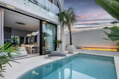 a swimming pool in the backyard of a house at Brand New Luxury5 Stars Designer By Villa-Amare Villa 5 in Kerobokan