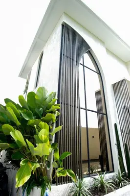 a building with a large window and some plants at Brand New Luxury5 Stars Designer By Villa-Amare Villa 5 in Kerobokan