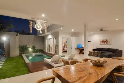 a living room with a table and a swimming pool at 3BR Villa3 Oberoi Seminyak,18Min walk to the beach in Seminyak