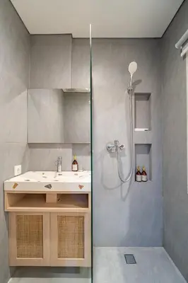 a bathroom with a sink and a shower at The Hita Uluwatu in Jimbaran
