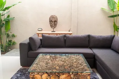 a living room with a couch with a table at 3BR Villa4 Oberoi Seminyak,18m walk to the beach in Seminyak