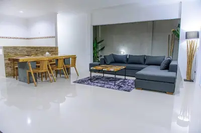 a living room with a blue couch and a table at 3BR Villa4 Oberoi Seminyak,18m walk to the beach in Seminyak