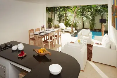 a kitchen and living room with a table and a pool at 2BR Villa Central Seminyak,50 m walk to the beach in Seminyak