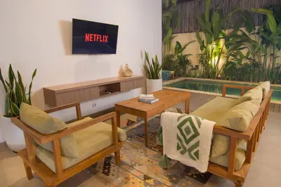a living room with two chairs and a table at LaBumbak 01 - 2BR Villa Escape in Umalas with Private Pool in Canggu