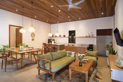 a living room with a dining table and a kitchen at LaBumbak 01 - 2BR Villa Escape in Umalas with Private Pool in Canggu
