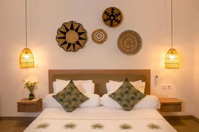 a bedroom with a bed with pillows on it at LaBumbak 01 - 2BR Villa Escape in Umalas with Private Pool in Canggu