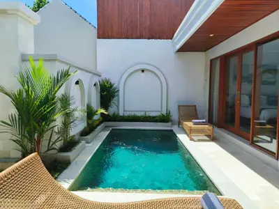 a swimming pool in the backyard of a house at Rumah Kodel4 by iBali Management in Seminyak