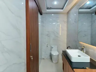 a bathroom with a white sink and a toilet at Rumah Kodel4 by iBali Management in Seminyak