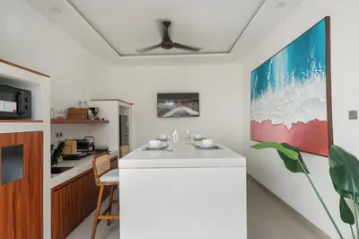 a kitchen with a white counter in a room at Queen Villa D1 by Betterplace in Seminyak