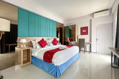 a bedroom with a large bed with red pillows at Garden Leaf Villa - 2 Bedroom Pool Villa with Minimum Stay 2 Nights in Nusa Dua