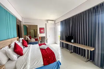 a bedroom with a large bed with red pillows at Garden Leaf Villa - 2 Bedroom Pool Villa with Minimum Stay 2 Nights in Nusa Dua