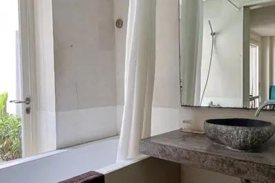 a bathroom with a sink and a mirror at Garden Leaf Villa - 2 Bedroom Pool Villa with Minimum Stay 2 Nights in Nusa Dua