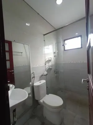 a bathroom with a toilet and a sink at Designer Alex Villa Jimbaran Bali in Jimbaran