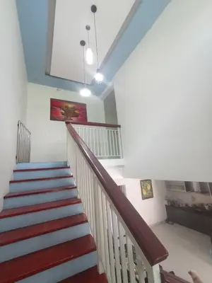a staircase in a house with red and blue stairs at Designer Alex Villa Jimbaran Bali in Jimbaran
