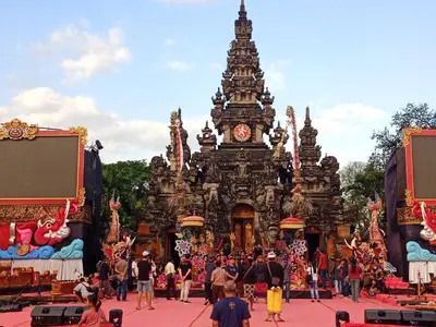 a group of people standing in front of a building with a clock at Designer Alex Villa Jimbaran Bali in Jimbaran
