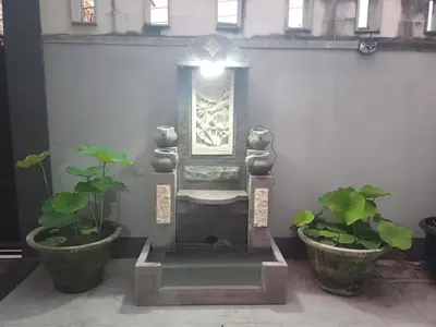 a statue in a room with two potted plants at Designer Alex Villa Jimbaran Bali in Jimbaran