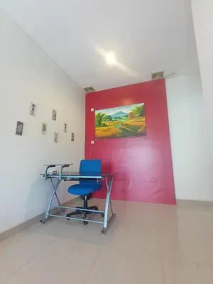 a room with a desk and a red wall at Designer Alex Villa Jimbaran Bali in Jimbaran