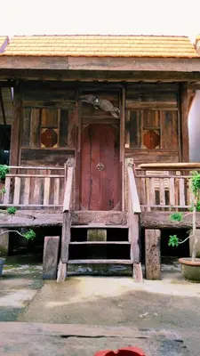 a wooden building with a large wooden door at Queen's Cabin in Kerobokan