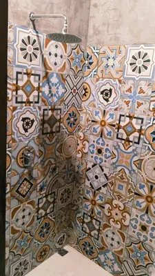 a bathroom with colorful tiles on the wall at Queen's Cabin in Kerobokan