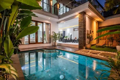 an indoor swimming pool in a house at Villa Shinta by JB Villas in Seminyak